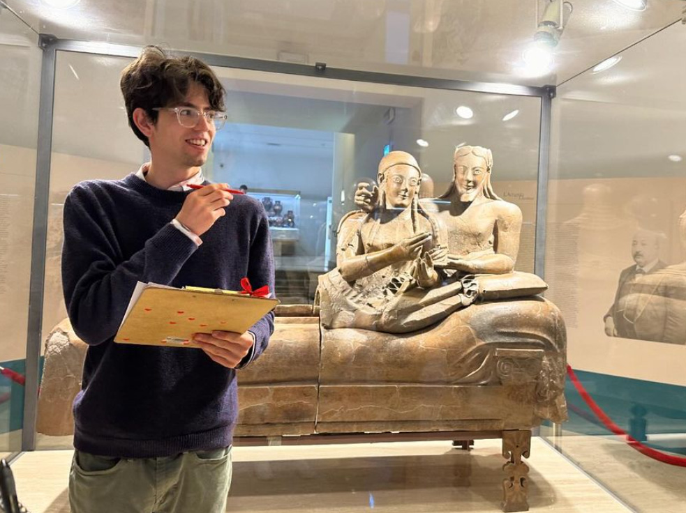 Will Schenck giving his site report in front of the famous Etruscan Sarcophagus of the Married Couple in the Villa Giulia Museum in Rome